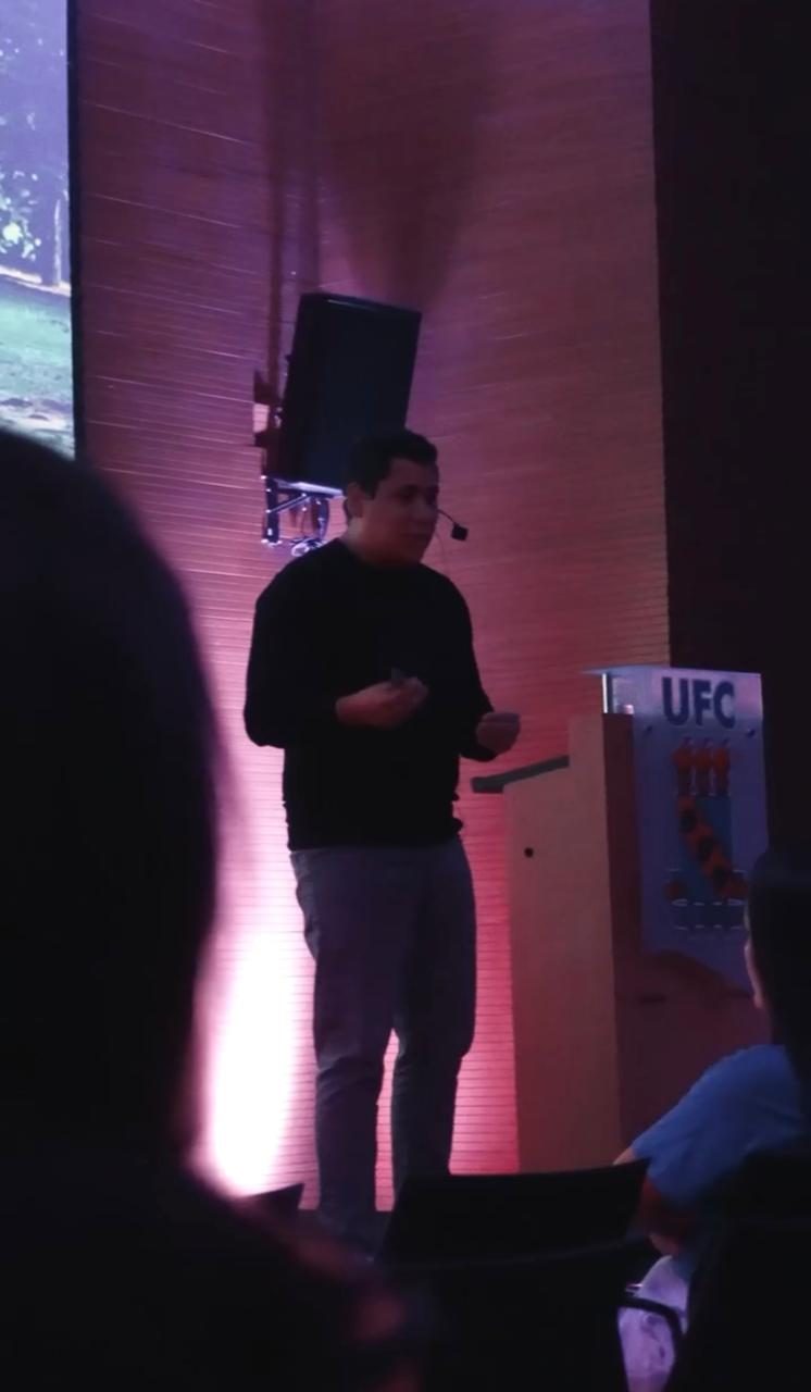 Dr. Augusto Câmara apresentando conteúdo sobre laminados cerâmicos em evento para dentistas
