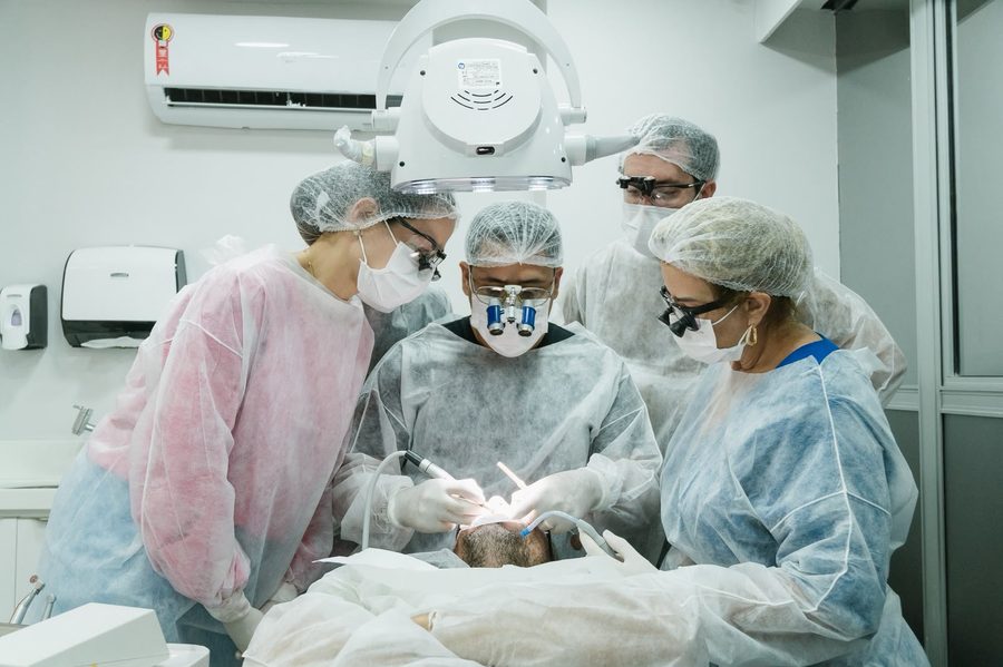 Turma acompanhando caso clínico ao vivo de laminados cerâmicos no consultório
